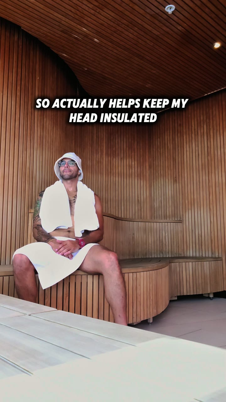 Xavier in a sauna wearing a Lucky Sauna hat